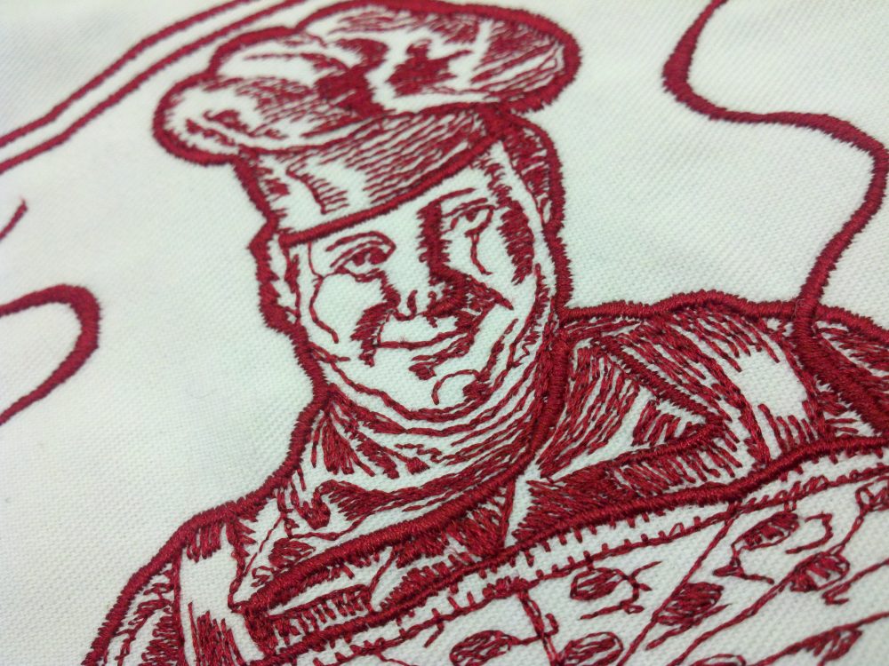 Embroidery design showing a pizza chef, created one stitch at a time in old digitizing software.