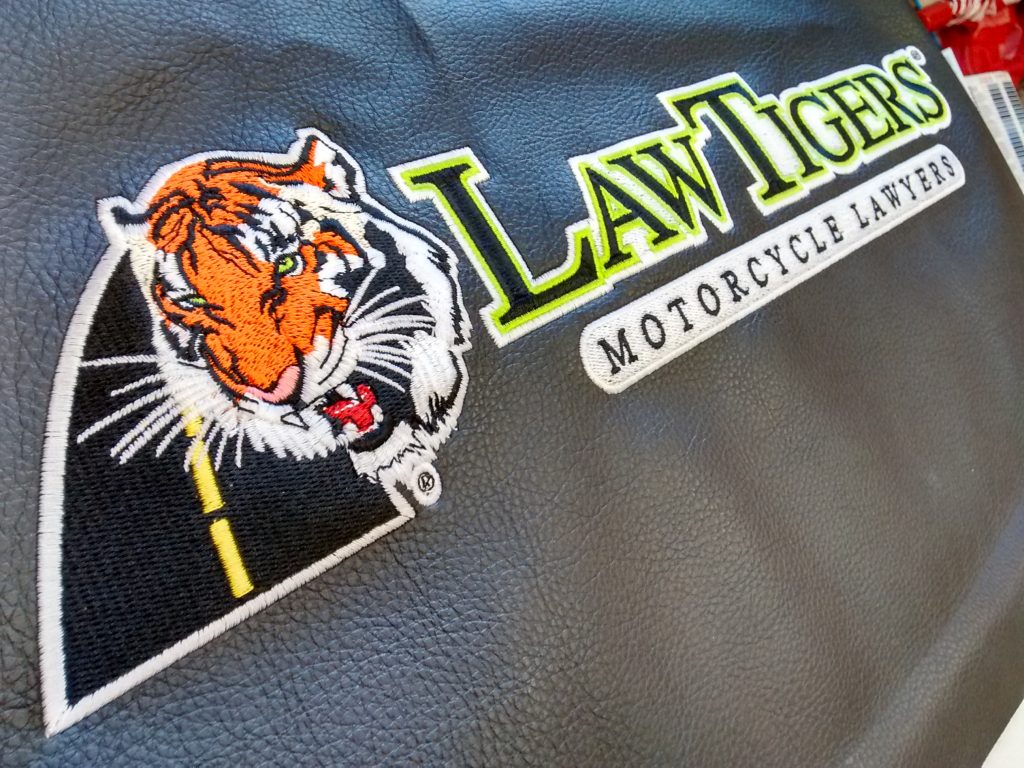 Embroidered Faux Leather Panel with Tiger Head Logo by Erich Campbell