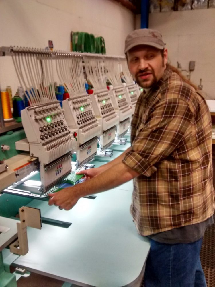 Erich Campbell at an embroidery machine